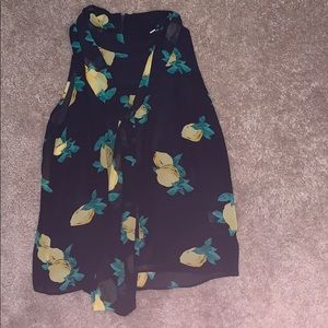 Sleeveless lemon blouse with ties at neck.